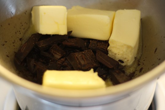Melt unsweetened chocolate and butter together in bowl over boiled water